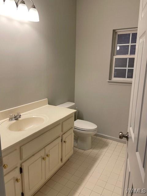 bathroom featuring tile patterned floors, vanity, and toilet