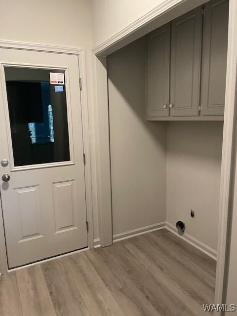 washroom featuring cabinets and light hardwood / wood-style flooring