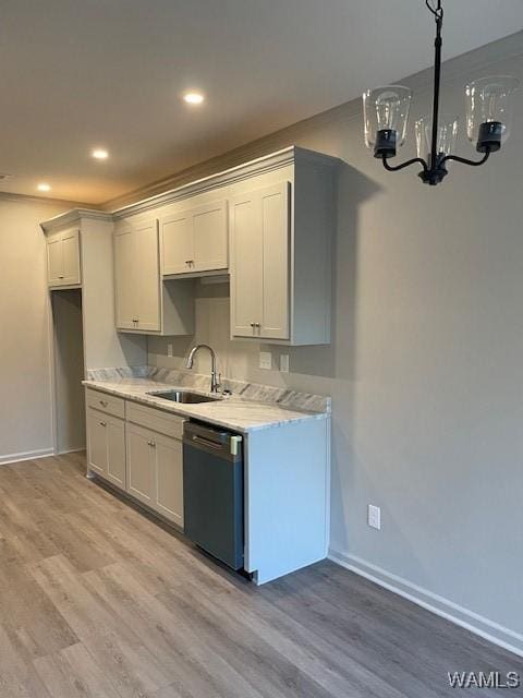 kitchen featuring sink, stainless steel dishwasher, white cabinets, and light hardwood / wood-style floors