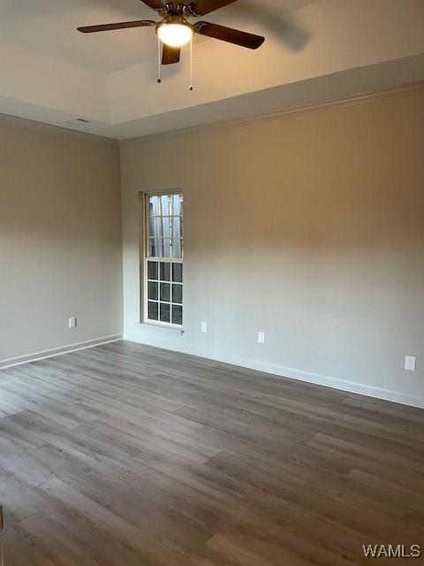 spare room featuring hardwood / wood-style floors and ceiling fan