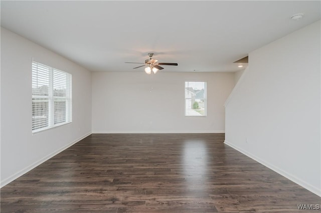 unfurnished room with ceiling fan and dark hardwood / wood-style floors