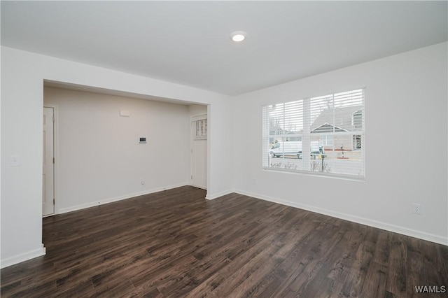 unfurnished room featuring dark wood-type flooring