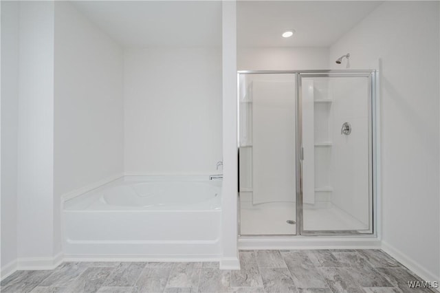 bathroom featuring separate shower and tub