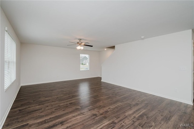 empty room with ceiling fan and dark hardwood / wood-style floors