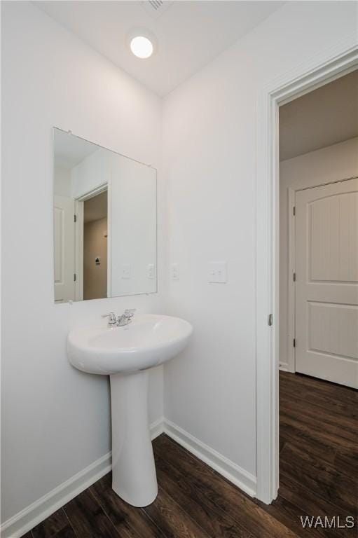 bathroom with hardwood / wood-style flooring