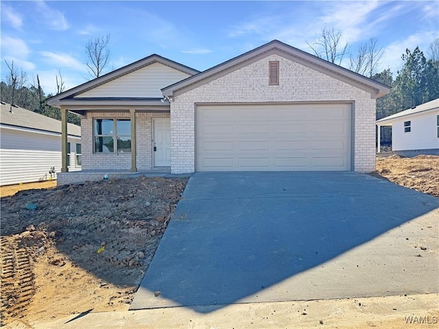 single story home with a porch and a garage