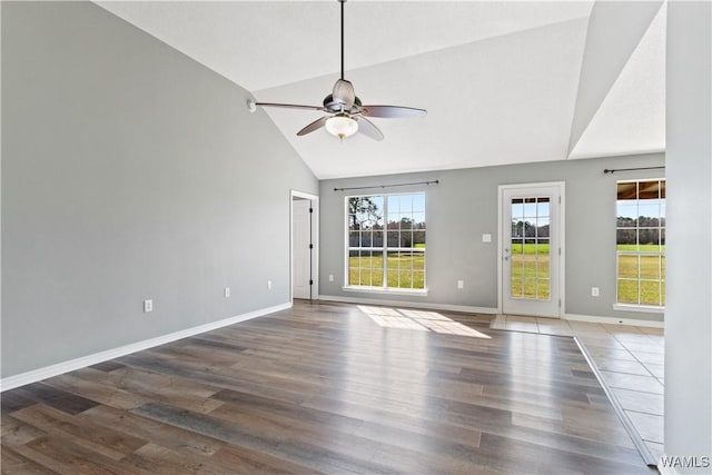 unfurnished room with high vaulted ceiling, baseboards, ceiling fan, and wood finished floors