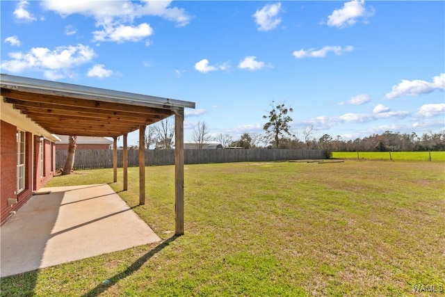 view of yard featuring a patio and fence