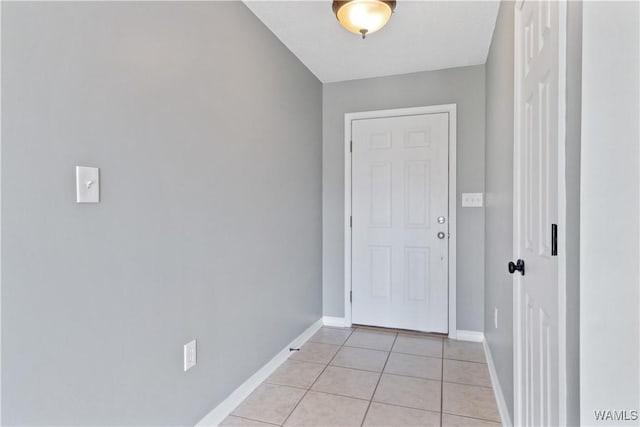 entryway featuring light tile patterned flooring and baseboards