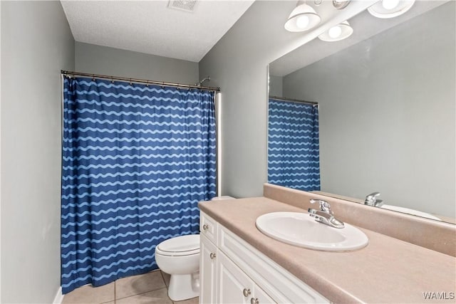 full bath featuring vanity, a shower with shower curtain, visible vents, tile patterned flooring, and toilet