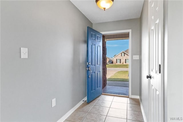 entrance foyer with light tile patterned floors and baseboards