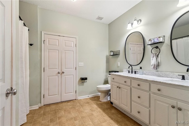 4458 19th St, Northport, AL 35476 - full bathroom featuring double vanity, toilet, and baseboards