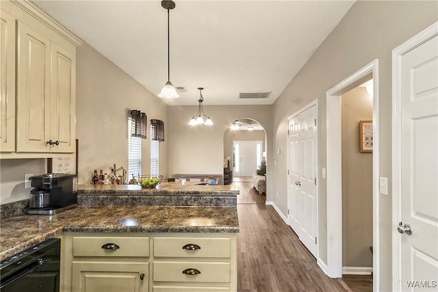 4458 19th St, Northport, AL 35476 - kitchen featuring a peninsula, black dishwasher, arched walkways, dark wood-style floors, and hanging light fixtures