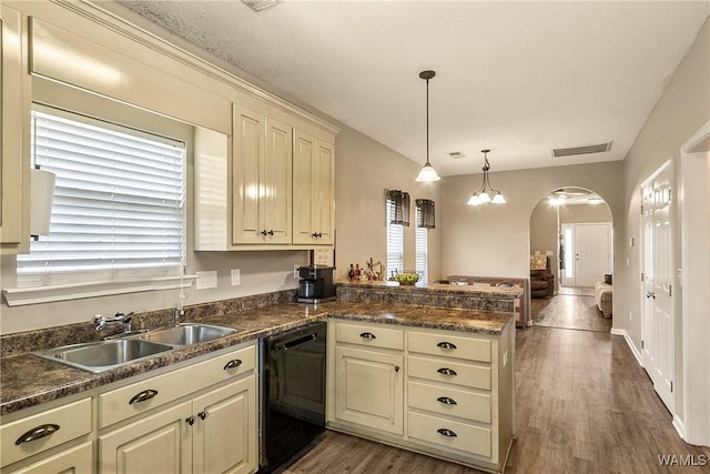 4458 19th St, Northport, AL 35476 - kitchen featuring dishwasher, a sink, arched walkways, a peninsula, and dark countertops