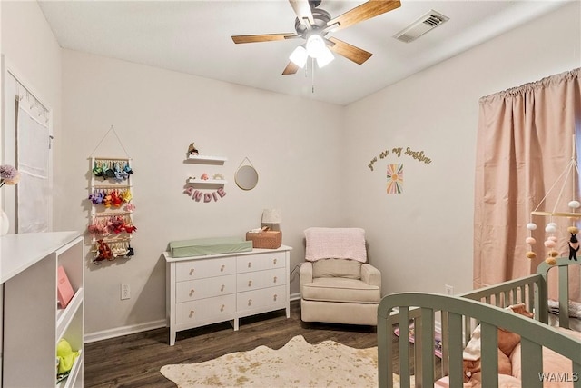4458 19th St, Northport, AL 35476 - bedroom with a crib, wood finished floors, baseboards, and a ceiling fan