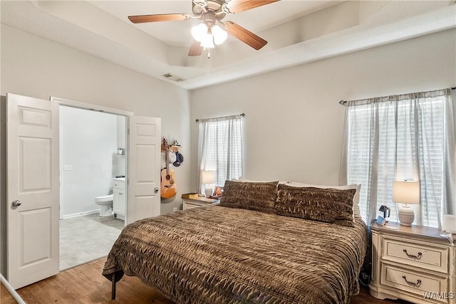 4458 19th St, Northport, AL 35476 - bedroom with light wood finished floors, ensuite bath, and ceiling fan