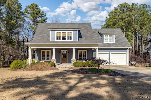 view of front facade featuring covered porch and a garage