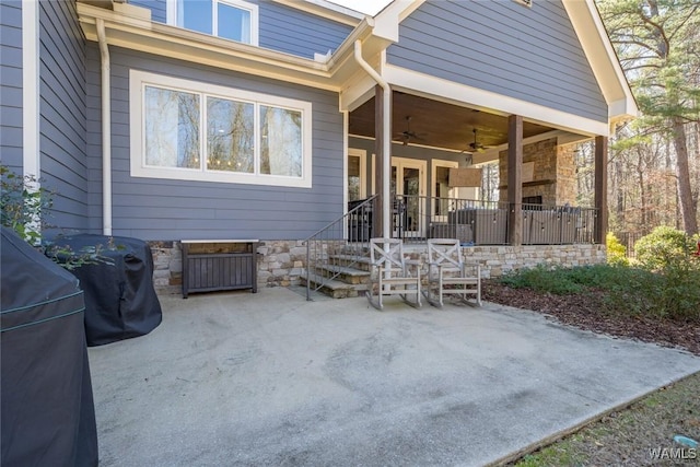 back of house with ceiling fan and a patio