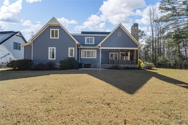 view of front of home with a porch and a front lawn