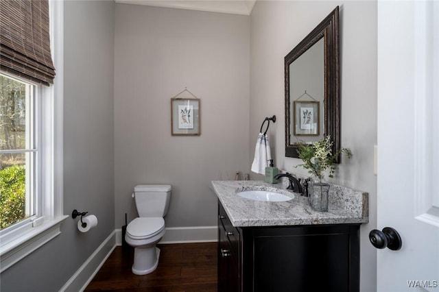 bathroom featuring hardwood / wood-style flooring, vanity, toilet, and plenty of natural light