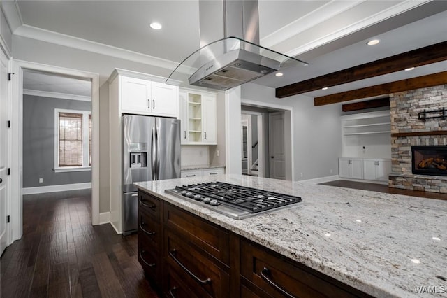 kitchen with light stone countertops, appliances with stainless steel finishes, baseboards, island exhaust hood, and glass insert cabinets
