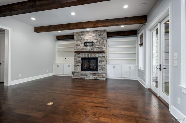 unfurnished living room with a stone fireplace, dark wood finished floors, beam ceiling, baseboards, and recessed lighting