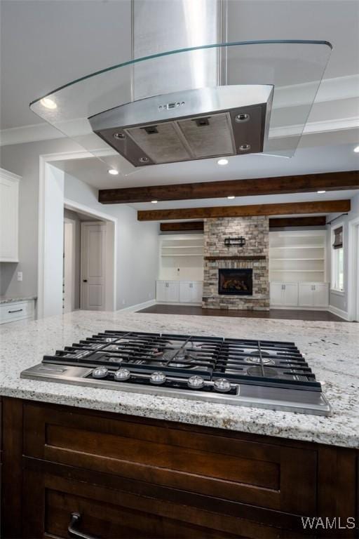 kitchen featuring white cabinets, light stone countertops, and dark brown cabinetry