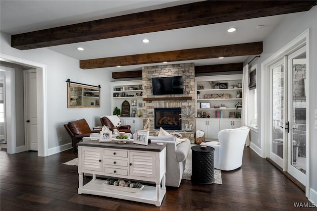 living room featuring a fireplace, dark hardwood / wood-style flooring, and built in features