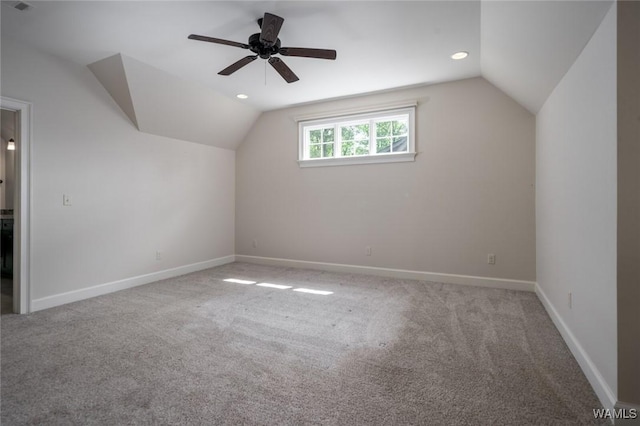 additional living space with carpet floors, baseboards, vaulted ceiling, and ceiling fan