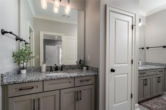 bathroom with crown molding and vanity