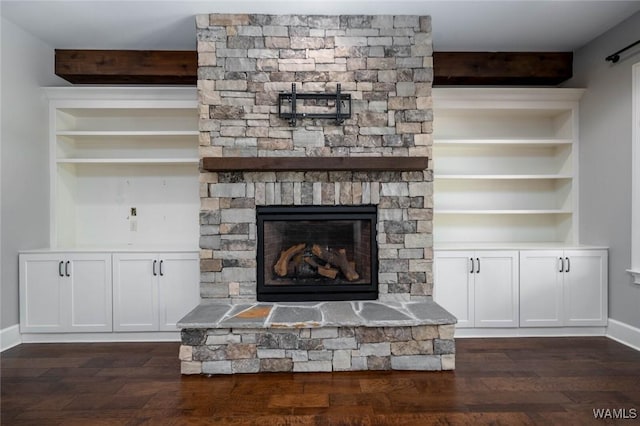 room details with a stone fireplace, baseboards, and wood finished floors