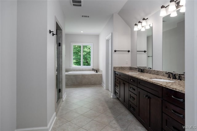 full bathroom featuring visible vents, a sink, a garden tub, and tile patterned flooring