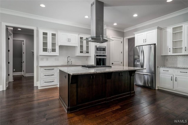 kitchen with decorative backsplash, island exhaust hood, appliances with stainless steel finishes, a center island, and a sink