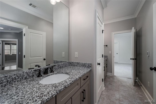 bathroom with baseboards, visible vents, ornamental molding, and vanity