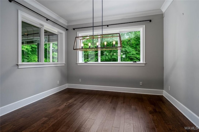 unfurnished dining area featuring baseboards, ornamental molding, and dark wood-style floors