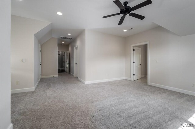 interior space featuring baseboards, visible vents, recessed lighting, and light colored carpet