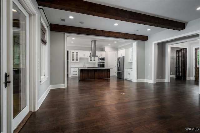 unfurnished living room featuring dark wood-style flooring, recessed lighting, baseboards, beamed ceiling, and ornamental molding
