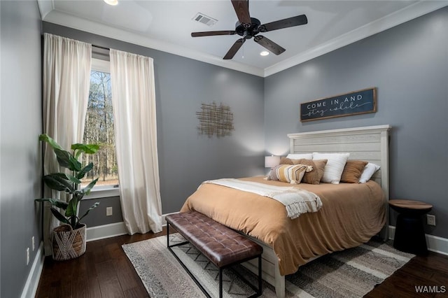 bedroom with ceiling fan, dark hardwood / wood-style floors, ornamental molding, and multiple windows