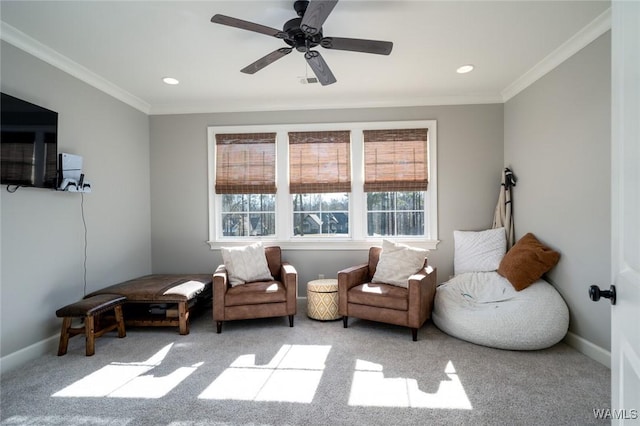 sitting room featuring light colored carpet, ceiling fan, and ornamental molding