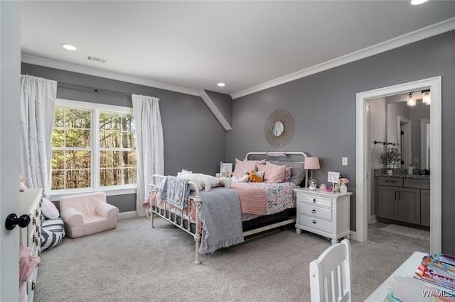 carpeted bedroom with ensuite bathroom and ornamental molding