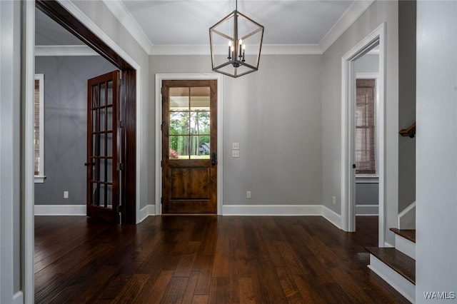 entryway with crown molding, stairs, a notable chandelier, and hardwood / wood-style flooring