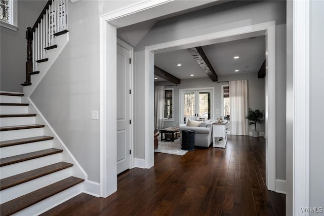 interior space with beam ceiling and dark wood-type flooring