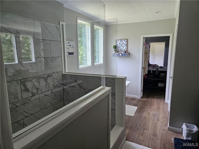930 Pine Tree Rd, Centreville, AL 35042 - bathroom featuring plenty of natural light, crown molding, wood finished floors, a walk in shower, and a textured ceiling