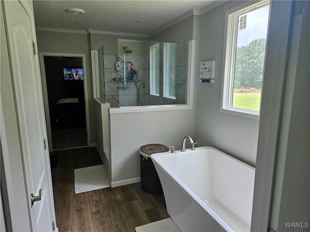930 Pine Tree Rd, Centreville, AL 35042 - bathroom with wood finished floors, a freestanding bath, walk in shower, and crown molding