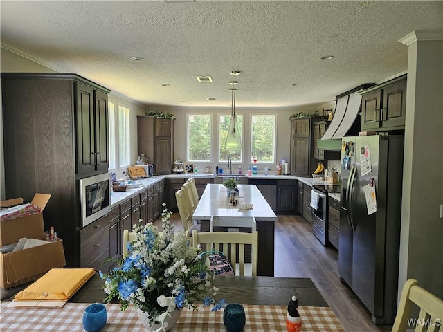930 Pine Tree Rd, Centreville, AL 35042 - kitchen featuring stainless steel appliances, wood finished floors, light countertops, ornamental molding, and a center island