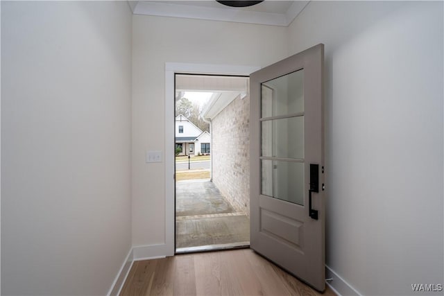 13947 Glenview Dr, Northport, AL 35475 - doorway to outside with crown molding, baseboards, and wood finished floors