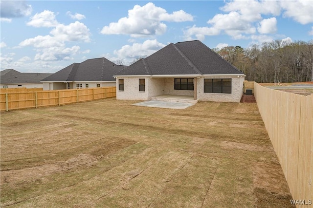 13947 Glenview Dr, Northport, AL 35475 - back of house with a fenced backyard, a lawn, and a patio area