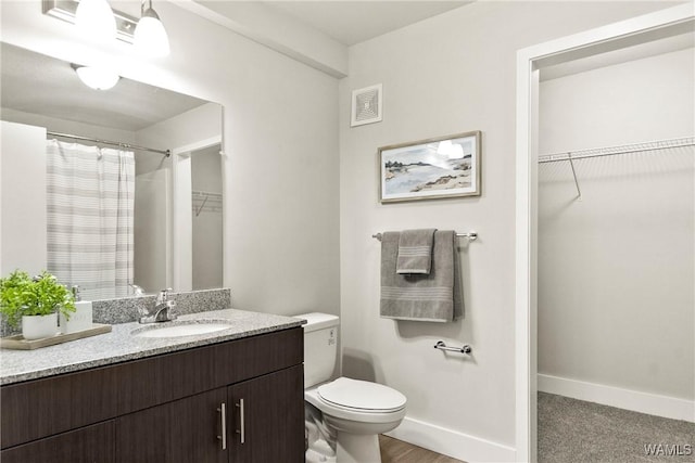 680 6th Ave NE Unit 3310, Tuscaloosa, AL 35404 - full bathroom with toilet, a walk in closet, vanity, and baseboards