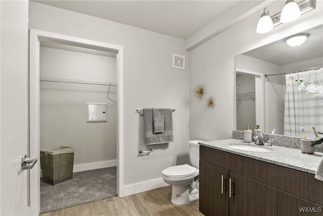 680 6th Ave NE Unit 3310, Tuscaloosa, AL 35404 - full bathroom with wood finished floors, vanity, a walk in closet, toilet, and baseboards