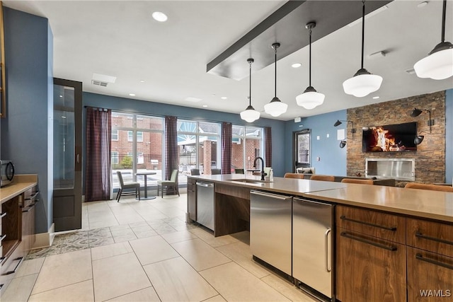 680 6th Ave NE Unit 3310, Tuscaloosa, AL 35404 - kitchen featuring a sink, dishwasher, light countertops, a stone fireplace, and recessed lighting